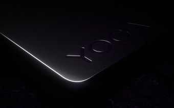A close-up of the Yoga logo engraved on the rounded corner of a Lenovo Yoga laptop.