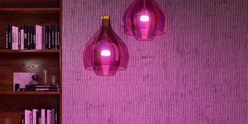 A pair of purple lamps hanging form the ceiling in a home-like background A pair of purple lamps hanging form the ceiling in a home-like background