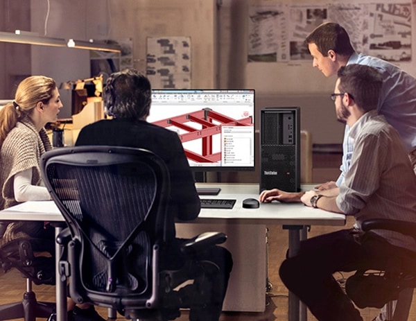 Gruppo di architetti che guardano un monitor, con progetti strutturali visualizzati sullo schermo, accanto a un dispositivo Lenovo ThinkStation P3 Tower