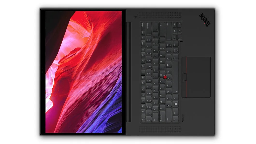 Aerial view of Lenovo ThinkPad P1 Gen 6 (16, Intel) mobile workstation, opened flat 180 degrees, showing full keyboard & display with flowing red and blue shapes on screen