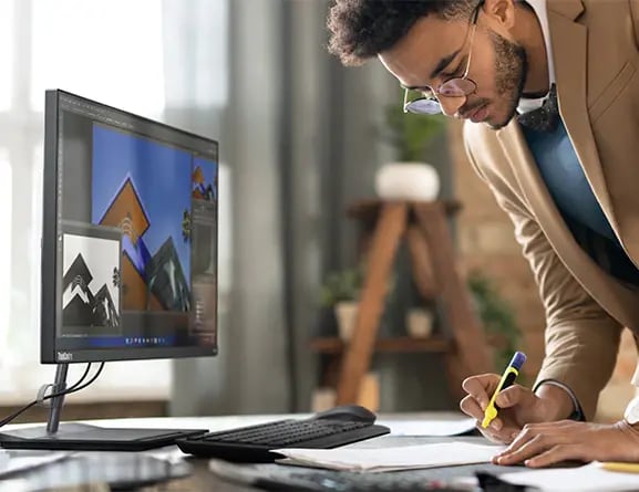ThinkCentre Neo 30a 23.8" AIO-Raven Black i5-1240P-16GB -512GB 7 Side view of someone using a Lenovo ThinkCentre Neo 30a (24” Intel) all-in-one business PC being in an office.