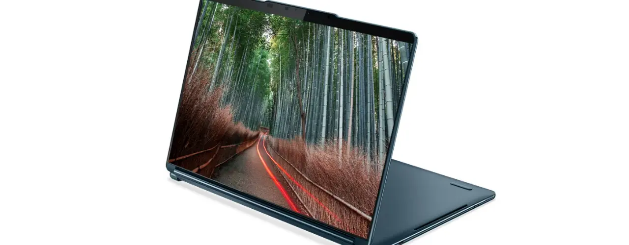 Angle view of the Lenovo Yoga Book 9i Gen 8 (13” Intel) 2-in-1 laptop in stand mode, with an image of a forest road on the display