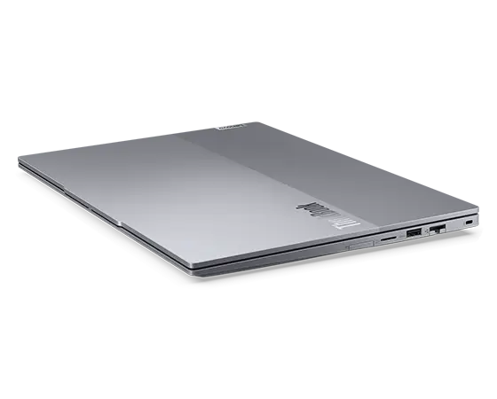 Rear-facing view of Lenovo ThinkBook 14 Gen 6+ (14 inch Intel) laptop, opened, at slight angle, showing top cover, part of keyboard, & right-side ports