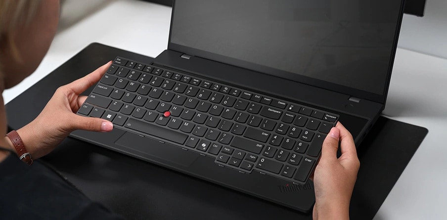 View of hands holding the customer replaceable unit – keyboard of Lenovo ThinkPad L16 laptop