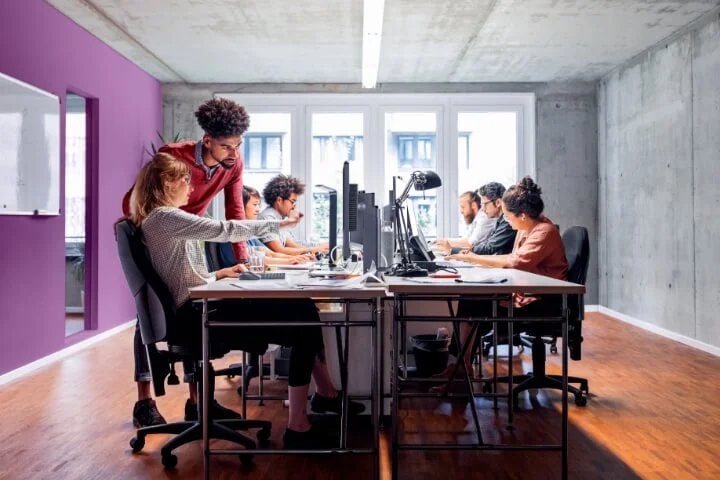 A group of IT professionals collaborating in a conference room