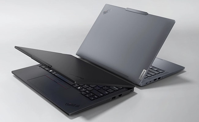 Two Lenovo ThinkPad T14 Gen 5 (14” AMD) laptops in Luna Grey & Eclipse Black placed back to back with their lids opened at acute angle, highlighting their rear side profiles.