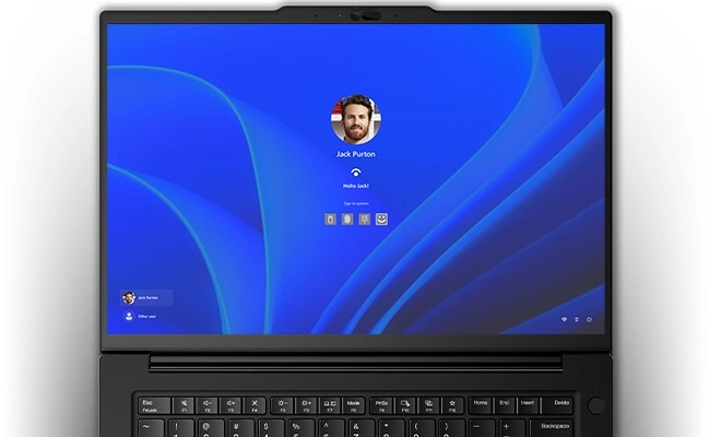 Overhead shot of the Lenovo ThinkPad P14s Gen 5 (14 inch Intel) black laptop with lid opened 180 degrees, showing only display that focuses Windows Hello facial recognition login feature & other login options.