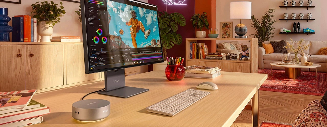 Lenovo Yoga Mini i Gen 11 (Intel) PC setup in a stylish, clean home office setup with a monitor and peripherals, focusing its smart connectivity & app features.