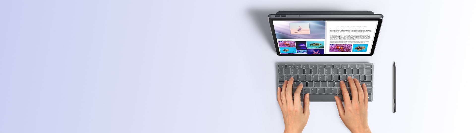 Vista superior de un usuario escribiendo en una tableta Lenovo con el teclado bluetooth y el lápiz digital colocado junto al dispositivo.