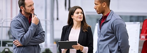 Three people with a Lenovo tablet talking