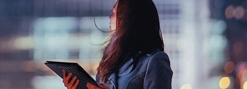 A woman using a Lenovo Tablet for work