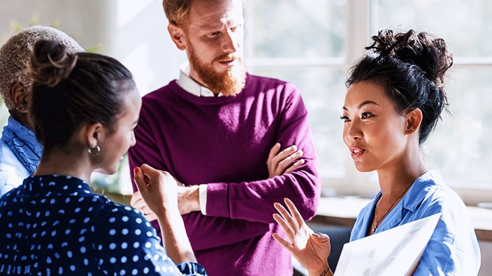 Group of coworkers talking together.
