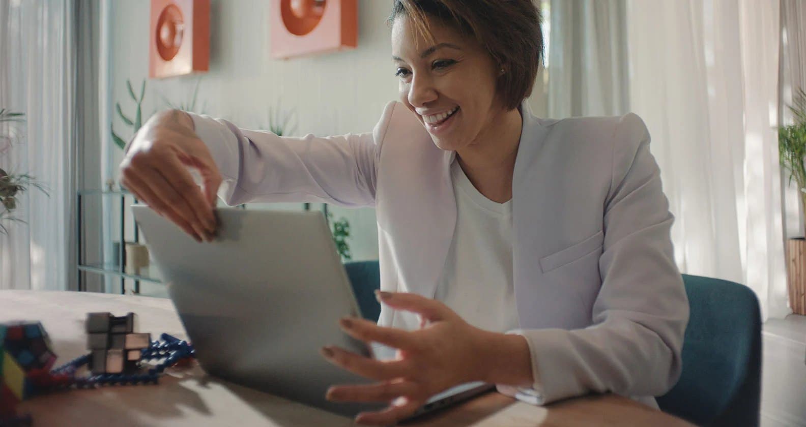 A business woman opening up her Lenovo laptop PC to start a video conference.