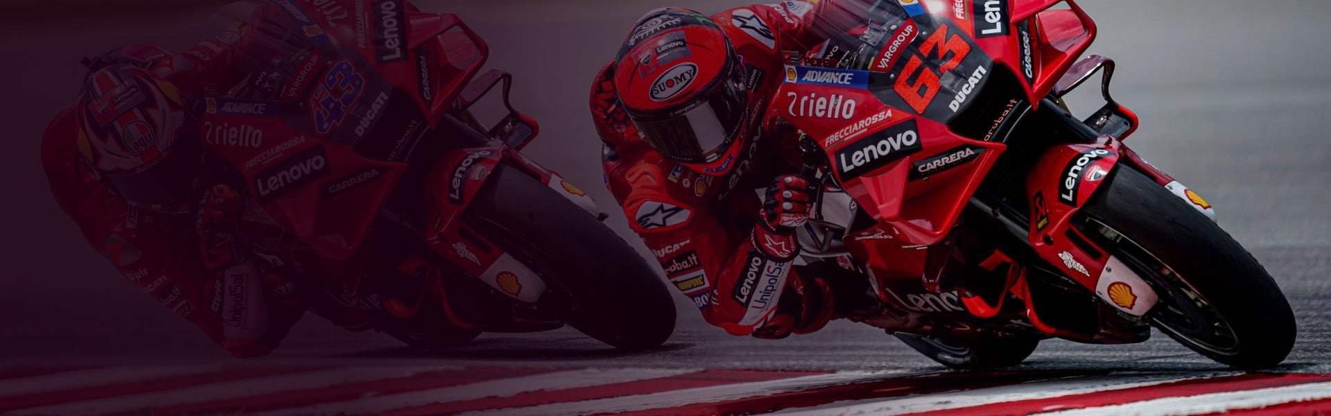 A motorcycle racer talking to his pit crew