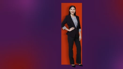 Femme professionnelle en costume noir sur un fond de gradient pourpre et rouge.