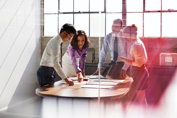 Four office workers collaborating in a conference room