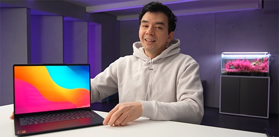 Dave2D holds a Lenovo Yoga Slim laptop. 