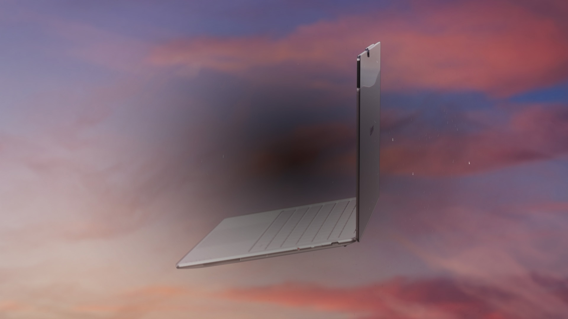 Right side view of a Yoga laptop against a colorful background of clouds.