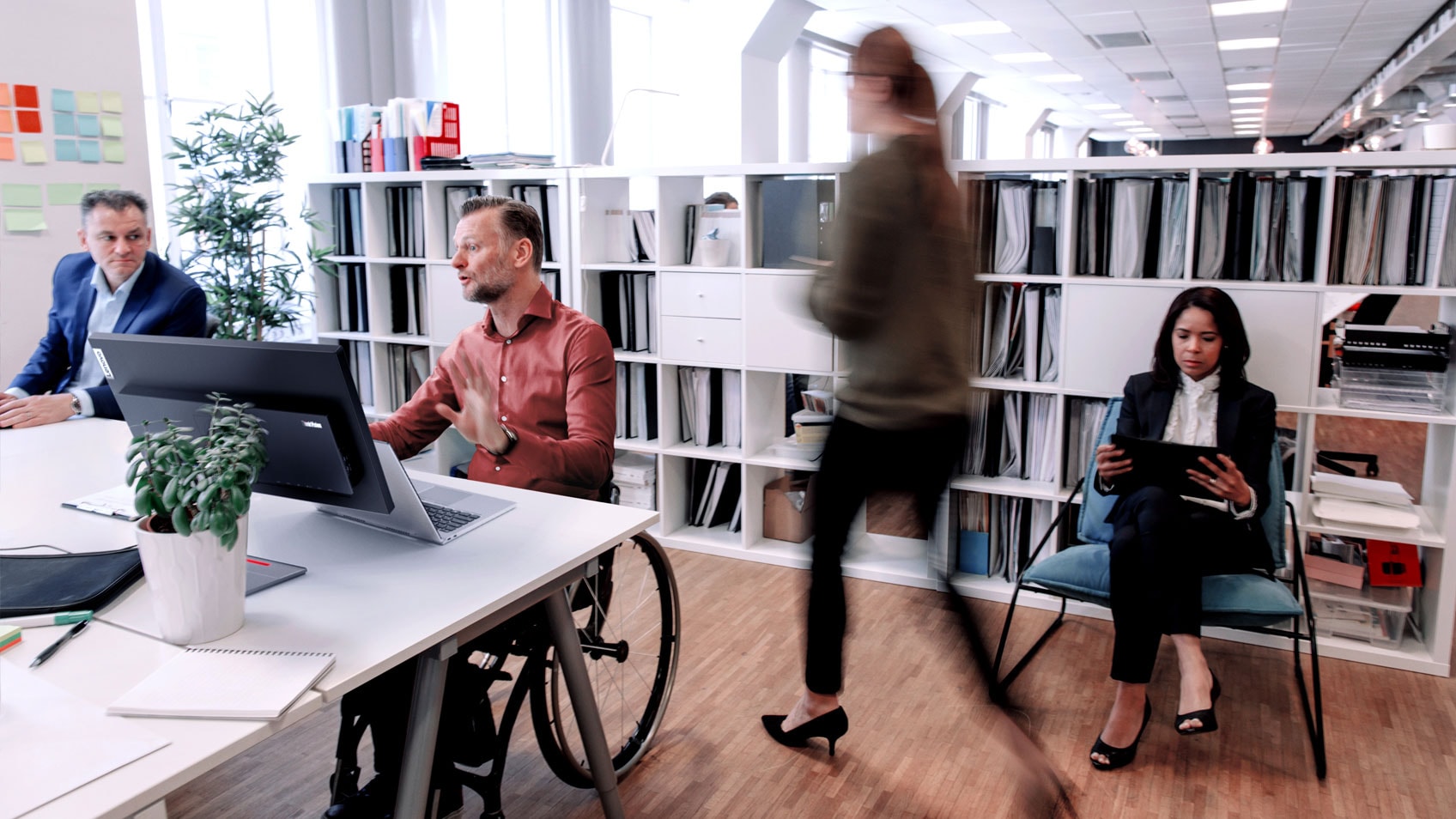 Colleagues busily working in the office