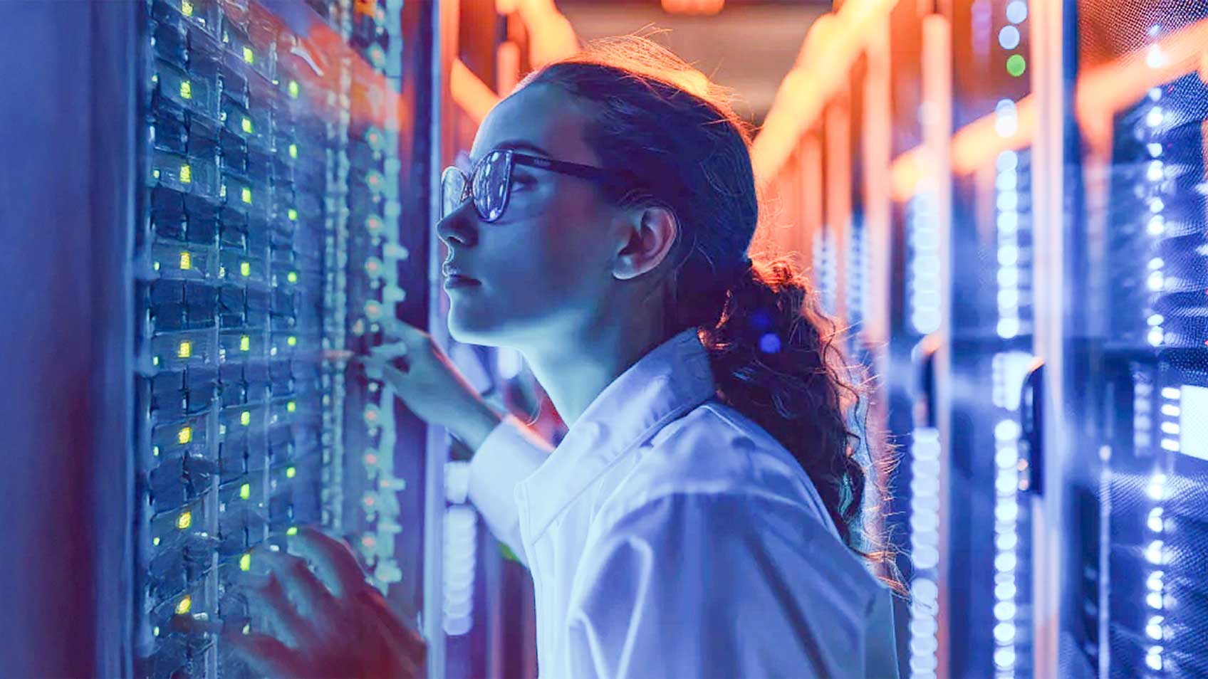 A woman working in a server room.
