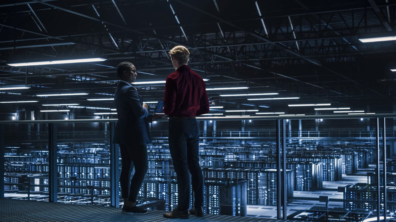 Two people overlooking a data center