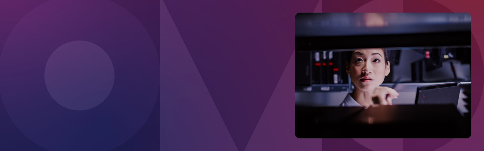 A woman examining servers in a data center