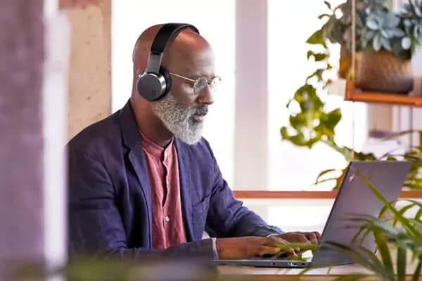 Man with headphones using a ThinkPad
