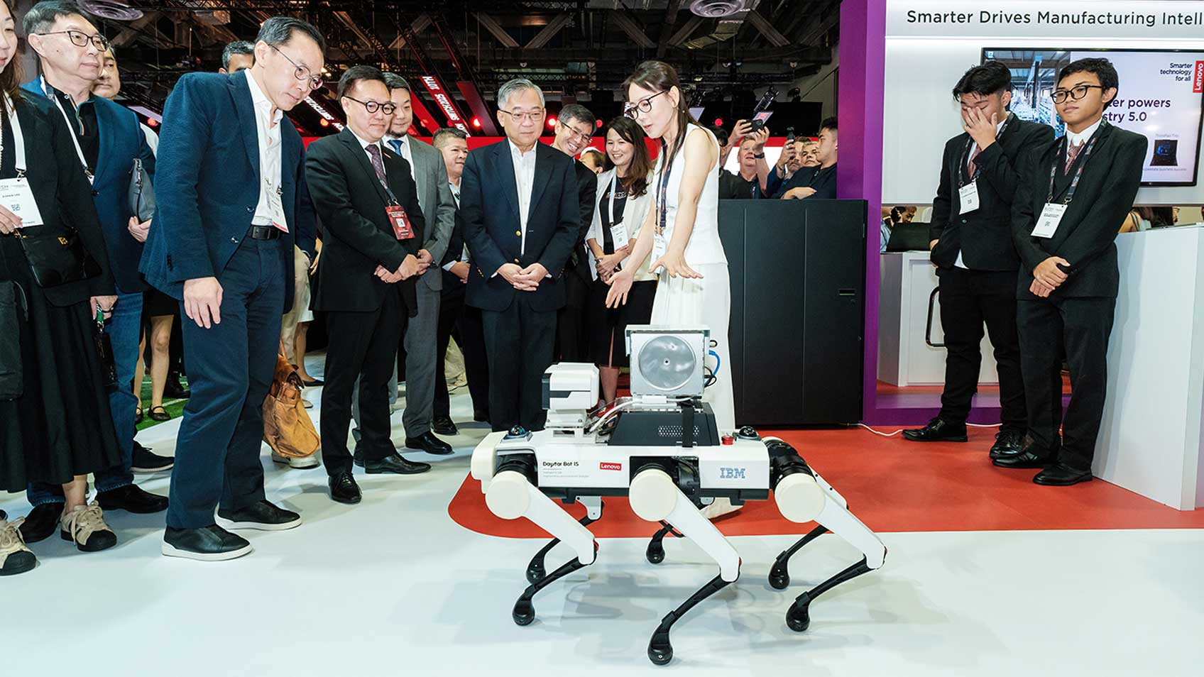 A Lenovo employe demonstrating a six-legged robot to onlookers at Singapore Week of Innovation and Technology (SWITCH).