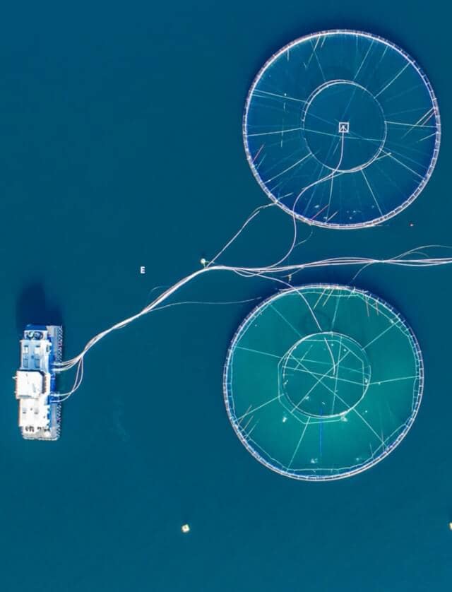 Overhead shot of a barge with various lines running toward two circles that resemble a circuit board. 