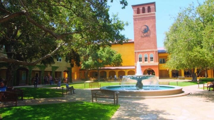 Picture of the Dreamworks campus featuring a fountain and beautiful trees all around.