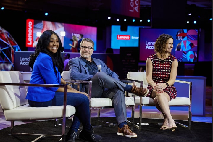 People sitting in chairs while hosting event