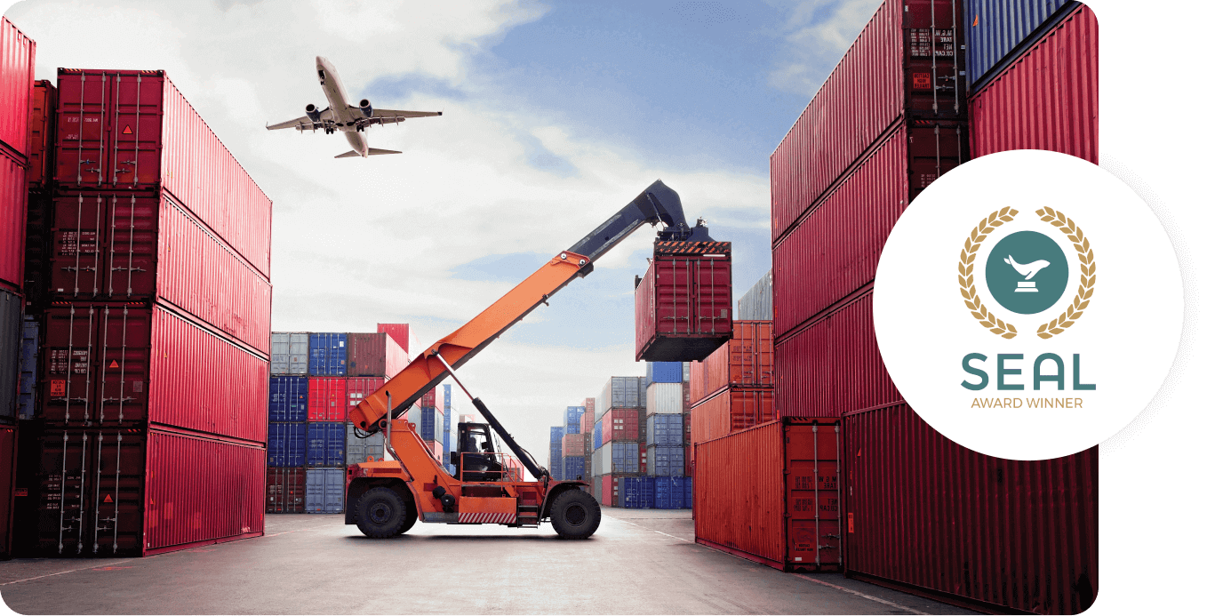 A plane flying over a shipping container yard with one being lifted by a crane with SEAL Sustainability Award