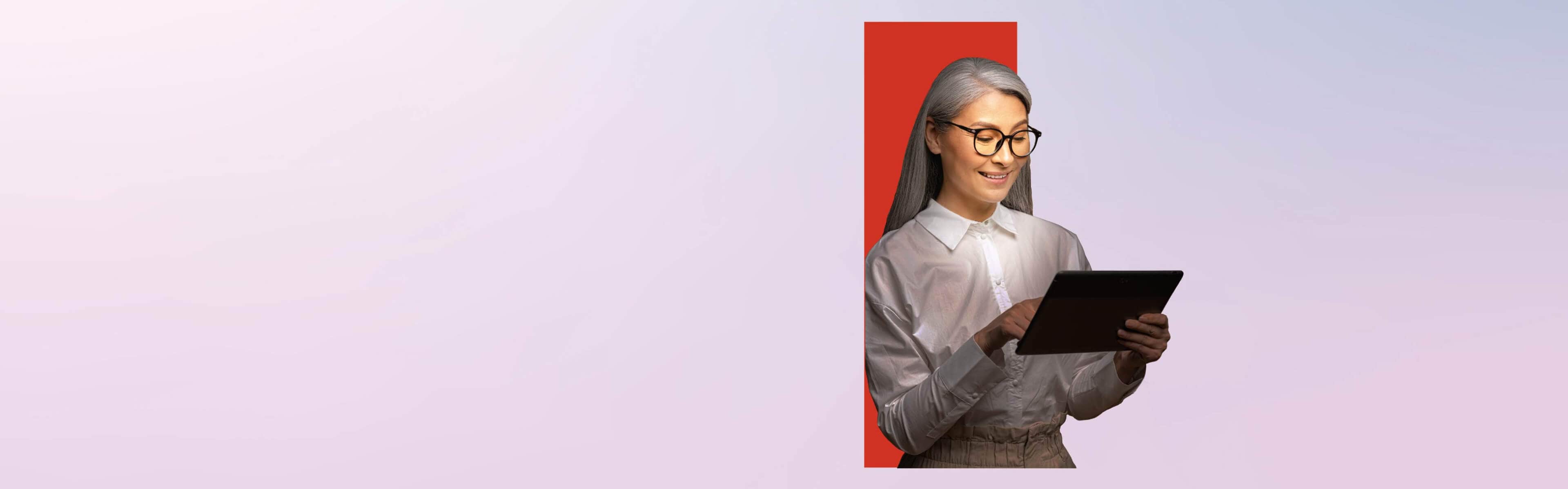 A woman standing in front of the red Lenovo portal and using a tablet