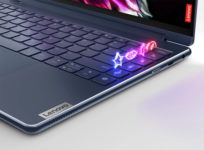 Top left closeup Lenovo Yoga Pro 9i, showing part of the keyboard with bright designs above the keys
