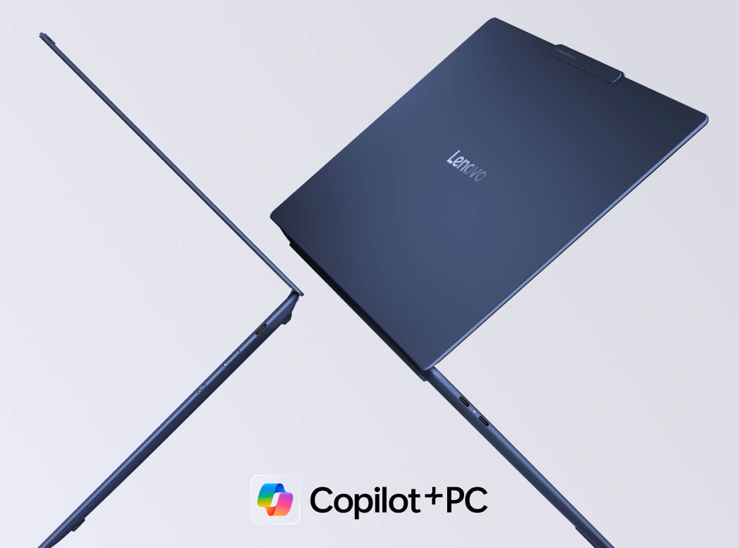 兩部 Lenovo Yoga 筆記簿型電腦背對背浮在半空中，顯示 Copilot+PC 標誌