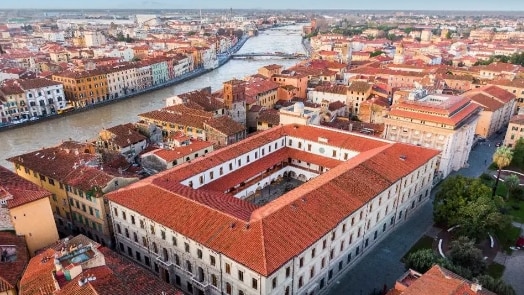 The image shows a panoramic picture of an European city with a river running along the center of it.