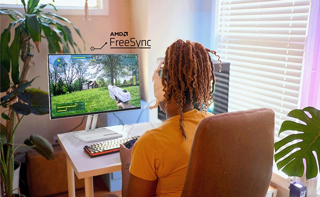 A person enjoys smooth visual experiences using the monitor with AMD FreeSync™ support.