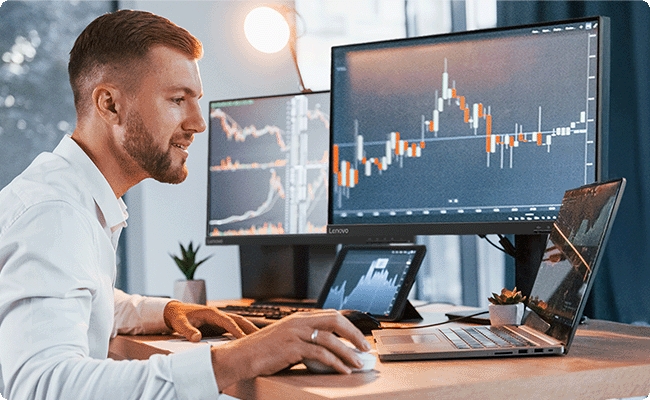 Lifestyle picture shows a man using the Lenovo l24-4e monitor which connect with multiple devices.