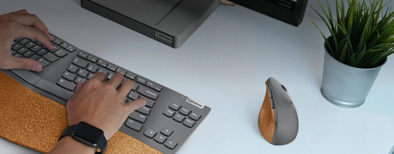 Lenovo Go Wireless Vertical Mouse on desk with other Lenovo products being operated by a user