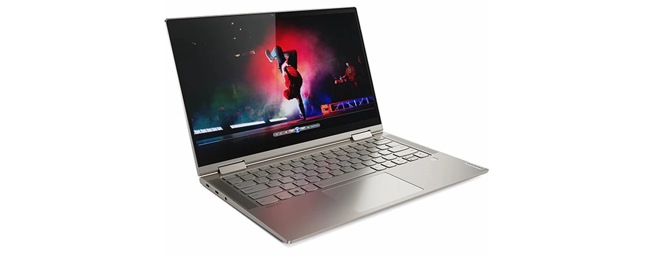 An Iron Grey Yoga C740 open at an angle, with a music video playing on the display