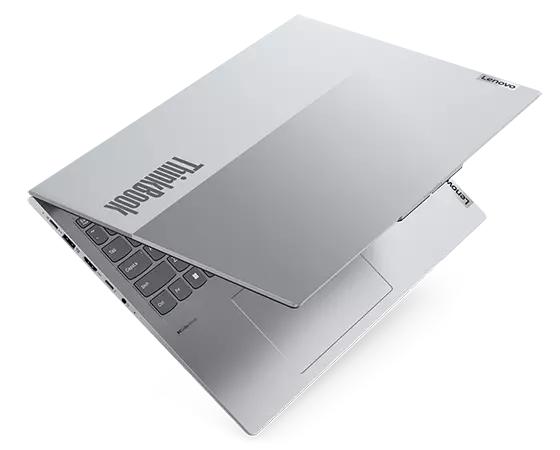 Overhead shot of Lenovo ThinkBook 16 Gen 4 laptop showing dual-tone top cover barely open & showing partial keyboard.