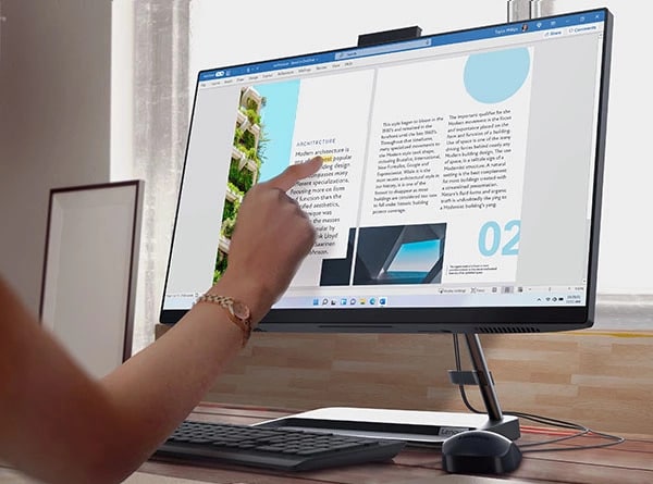 A hand touching the IdeaCentre AIO 3i Gen 7 All-in-one PC screen.